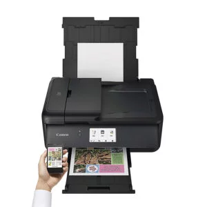 A Canon PIXMA TS9550 printing a document wirelessly via an iPhone.