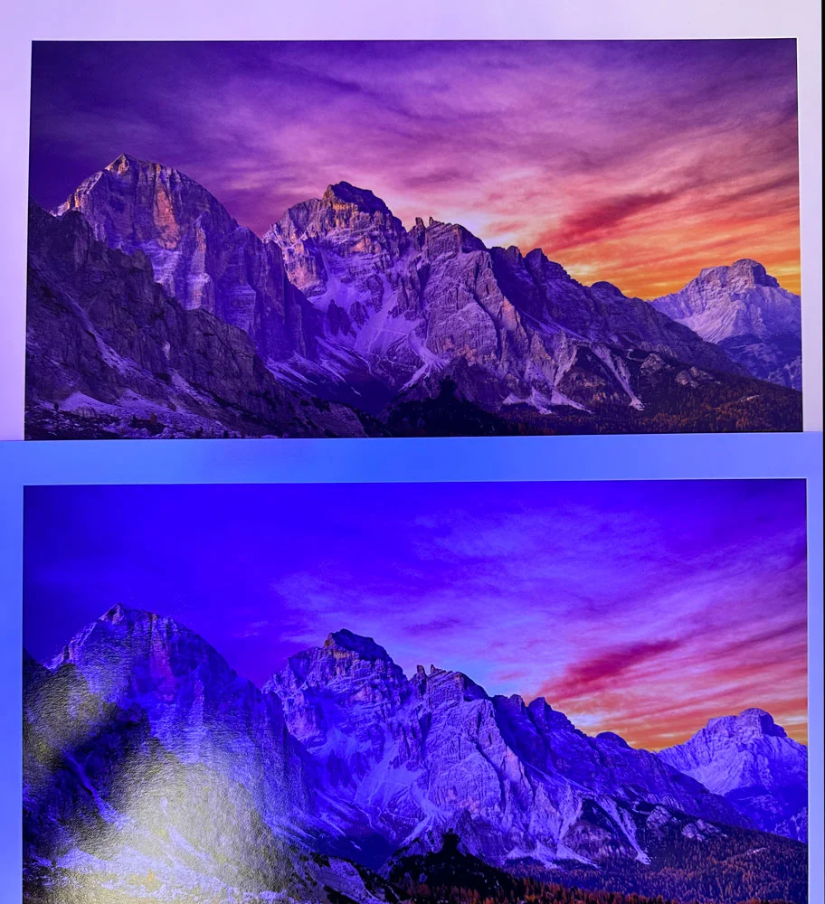 Two side by side prints of mountains that have a UV light shining on them