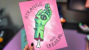 A print of a green hand on a pink background